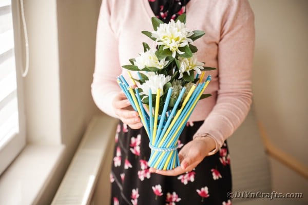 Woman holding twisted vase