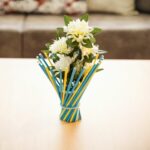 Colorful stick vase on wood table