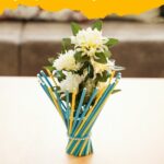 Colorful stick vase on wood table