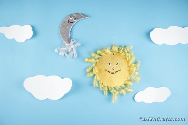 Sun and moon decoration on blue wall with clouds