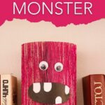 Old book pink monster craft on stack of books