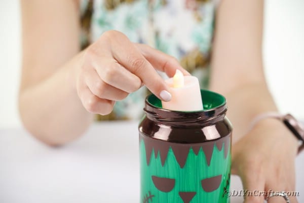 Adding candle to mason jar