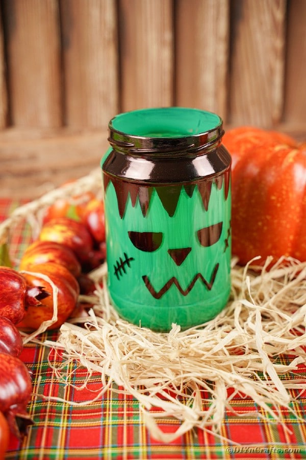 Mason jar frankenstein on hay by pumpkins