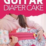 Woman holding diaper guitar