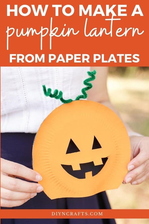 Woman holding paper plate pumpkin
