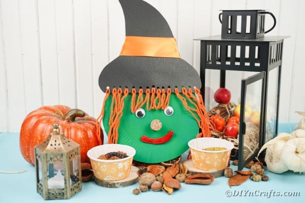 Paper plate witch face with Halloween decorations