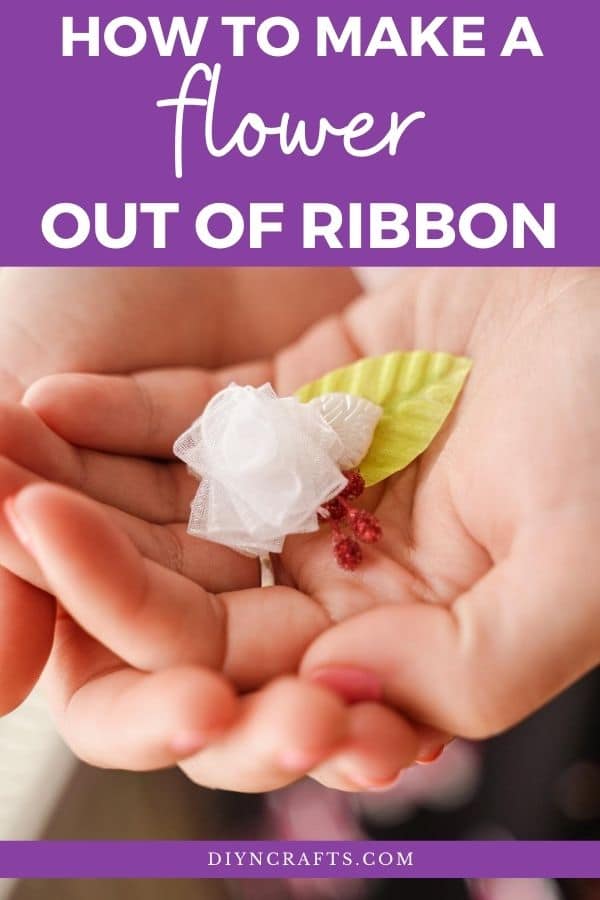 Woman holding miniature ribbon flower