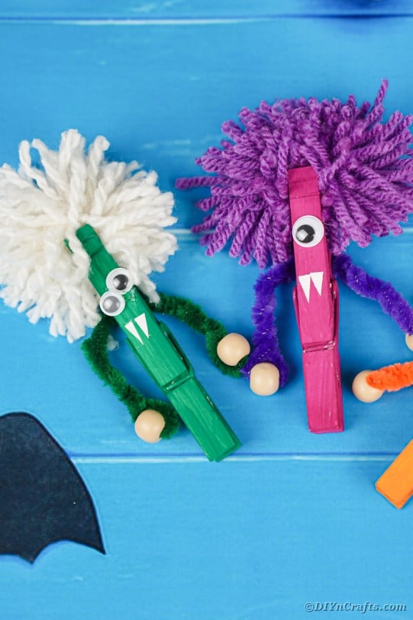 Clothespin monsters on blue boards