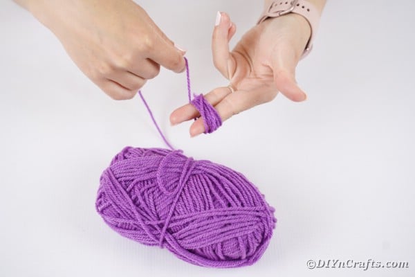 Winding yarn around hand