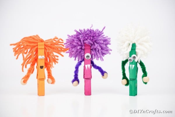 Clothespin monsters on white surface