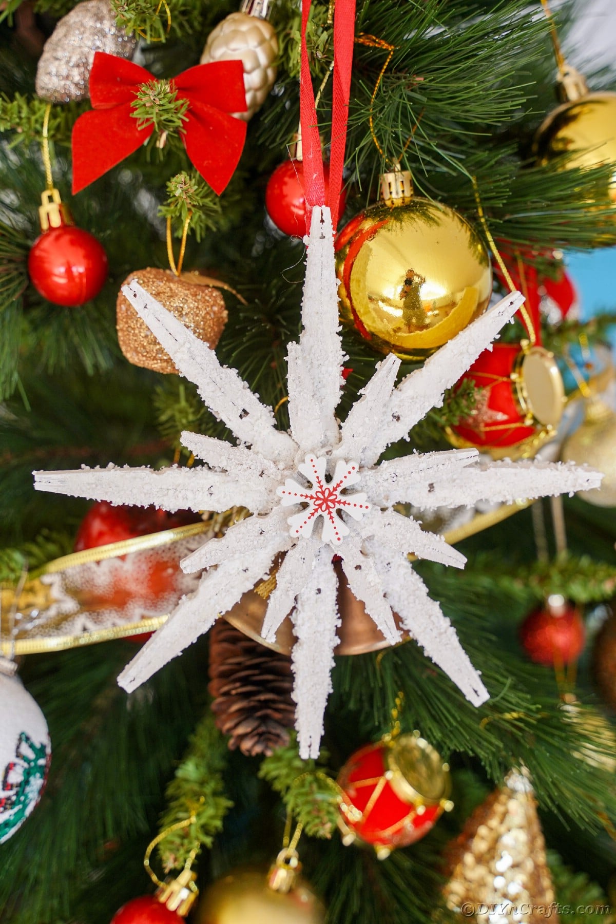 clothespin snowflake hanging on christmas tree