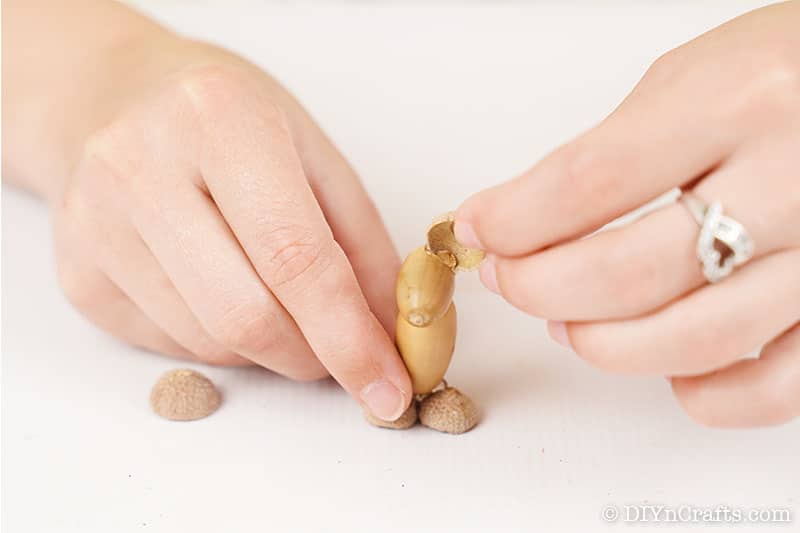 Adding the right ear to a DIY animal decoration from acorns