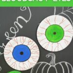 Paper plate bloodshot eyeballs on Halloween chalkboard
