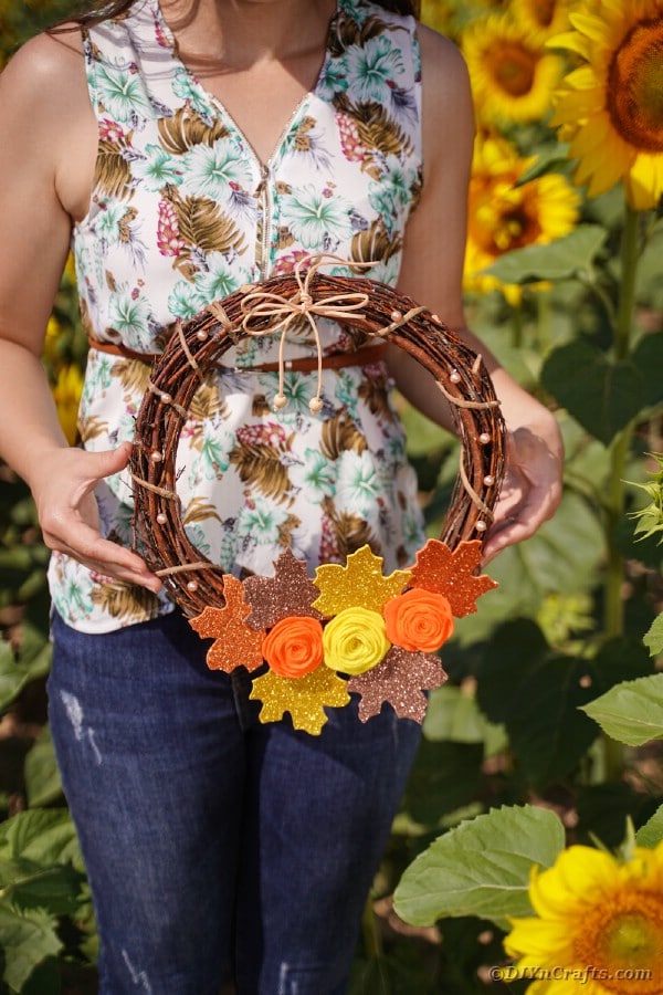 Woman holding fall wreath