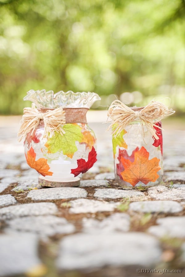 Two fall leaf jars on rocks