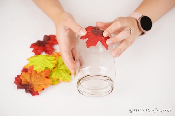 Gluing leaves to jar