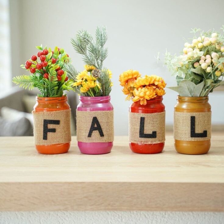Lettered fall mason jar decor on a table