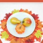 Fake fruit on white plate on placemat