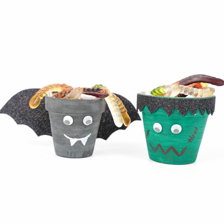 Flower pot Halloween characters on white table