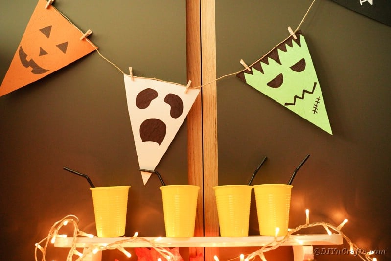 Halloween bunting hanging by orange cups