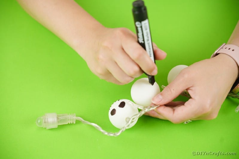 Drawing face on ping pong ball