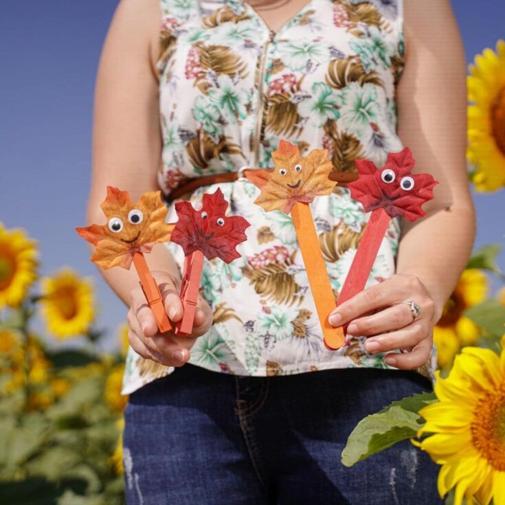 Woman holding leaf people