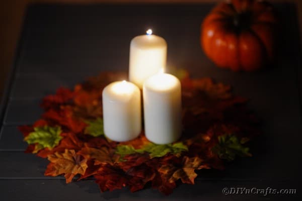 Candles lit on leaf fall placemat