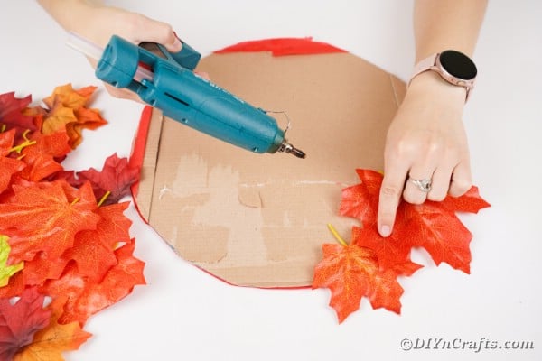 Gluing leaves onto cardboard