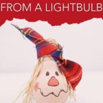 Lightbulb scarecrow on white surface