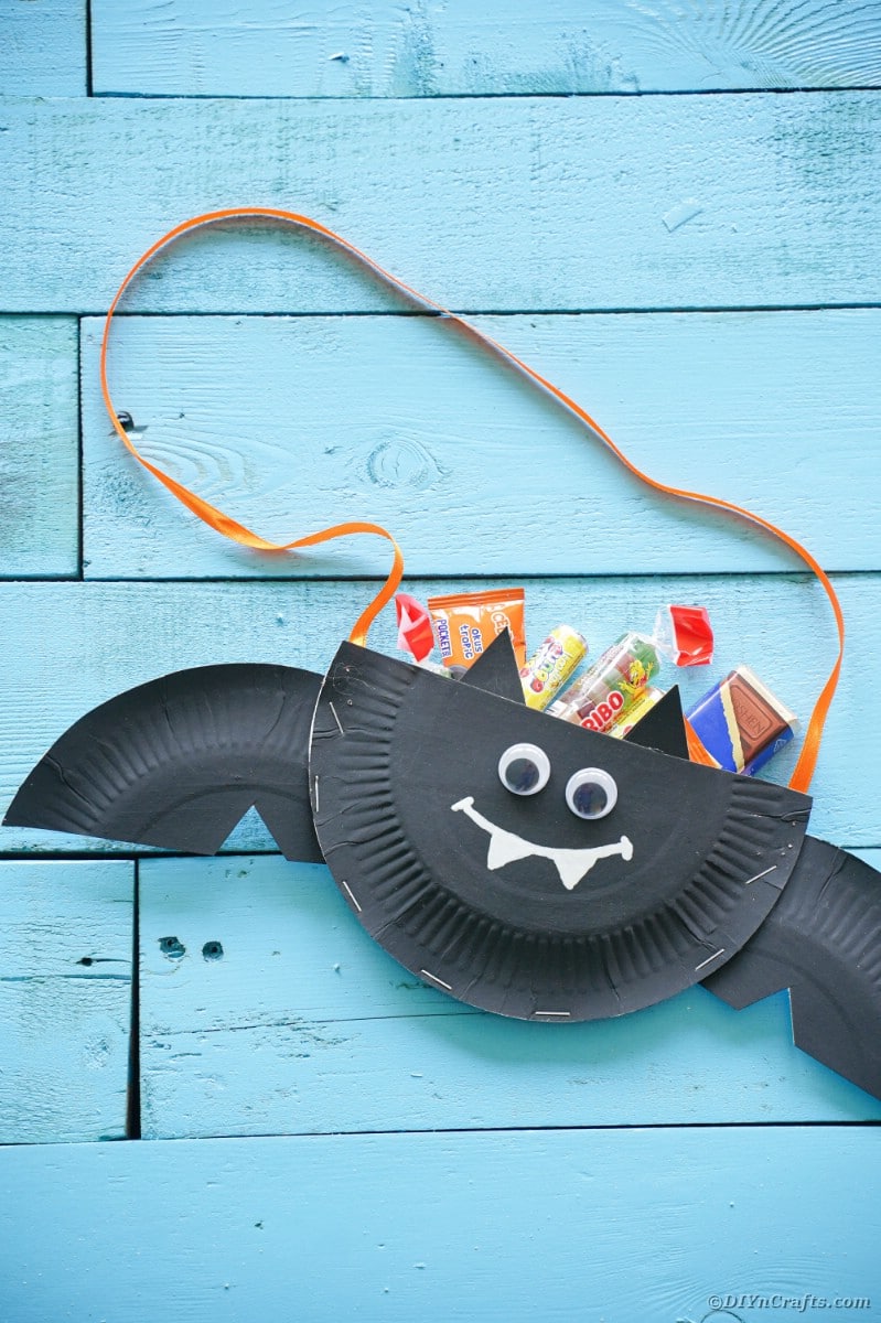 Bat filled with candy on blue boards