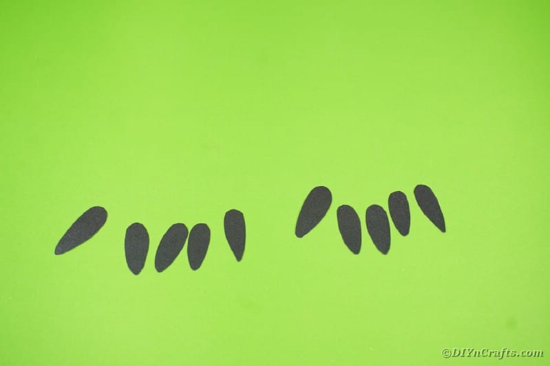Black paper fingernails on green table