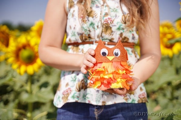 Woman holding tin can owl