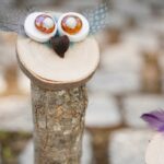 Tall wooden owl on cobblestone