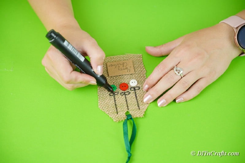 creating burlap gift tags with marker on table
