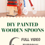 Painted spoons leaning against a wooden tree