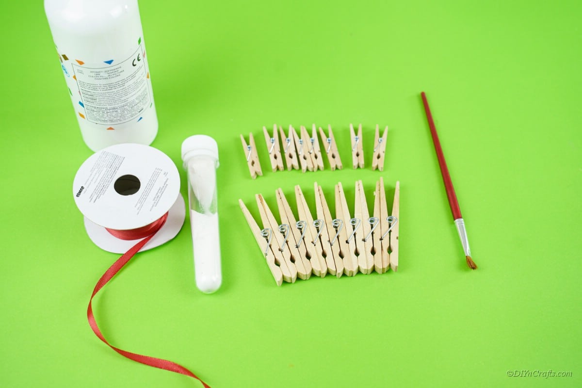 craft supplies clothespins paint brush ribbon glue