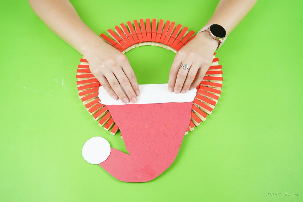 gluing red hat onto craft