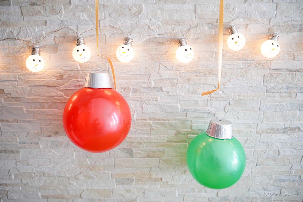 Giant ornaments made form rubber balls hanging from Christmas lights