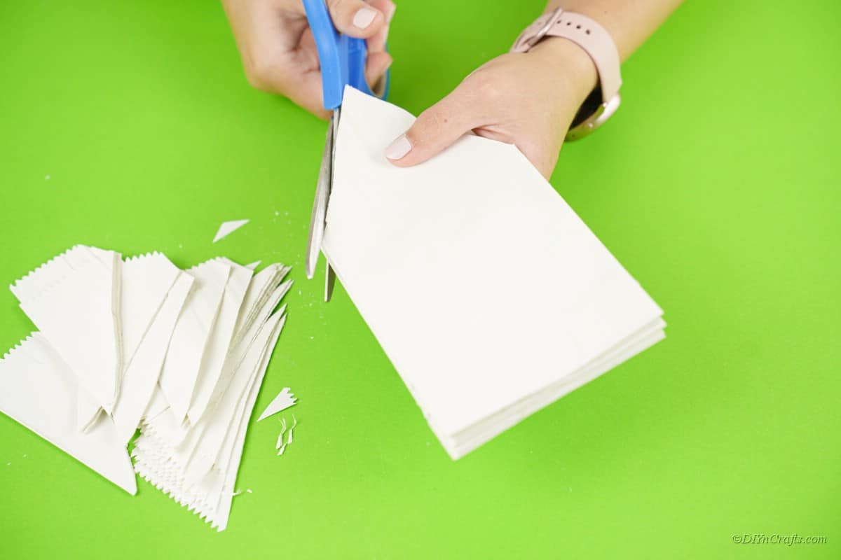 scissors cutting white paper bag