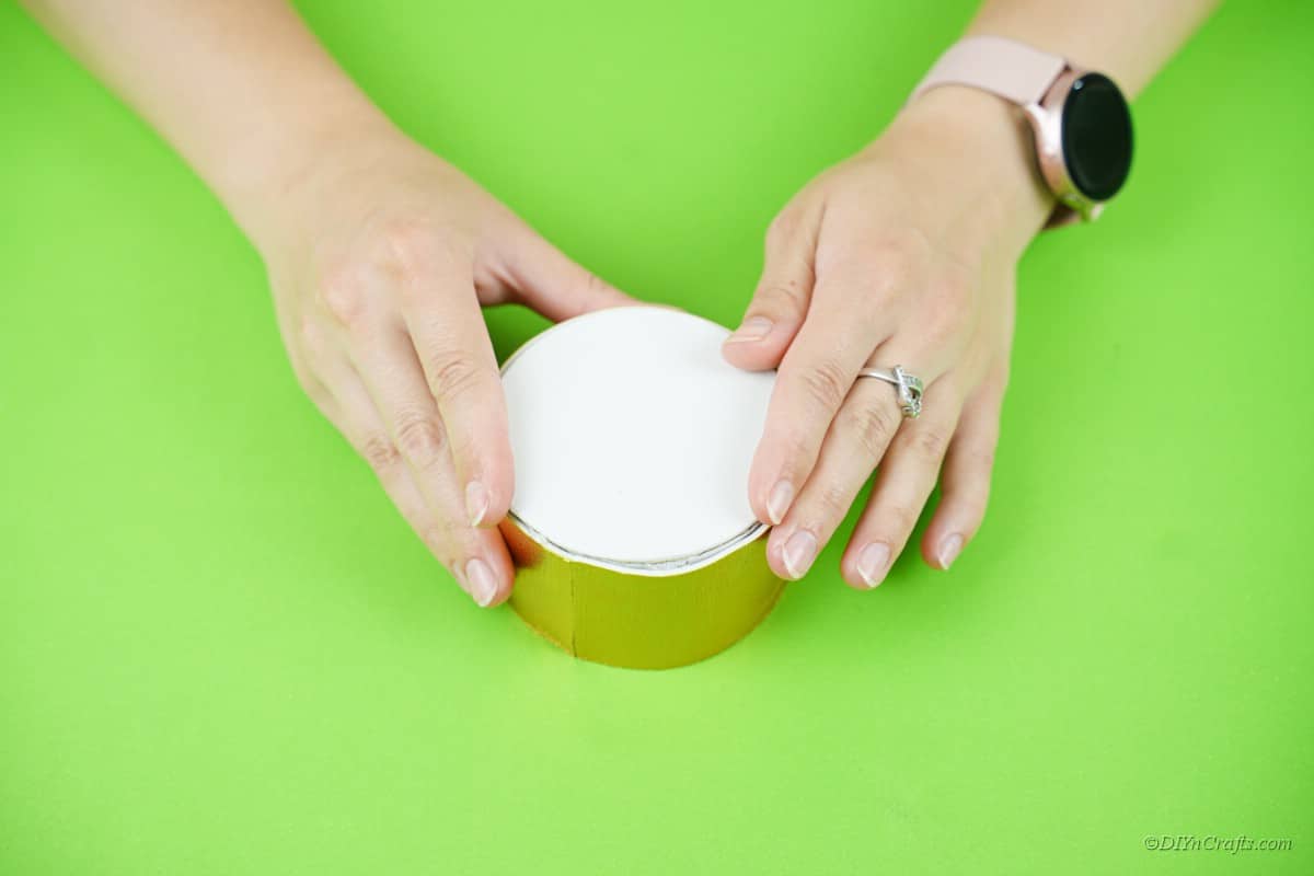 woman holding small paper craft