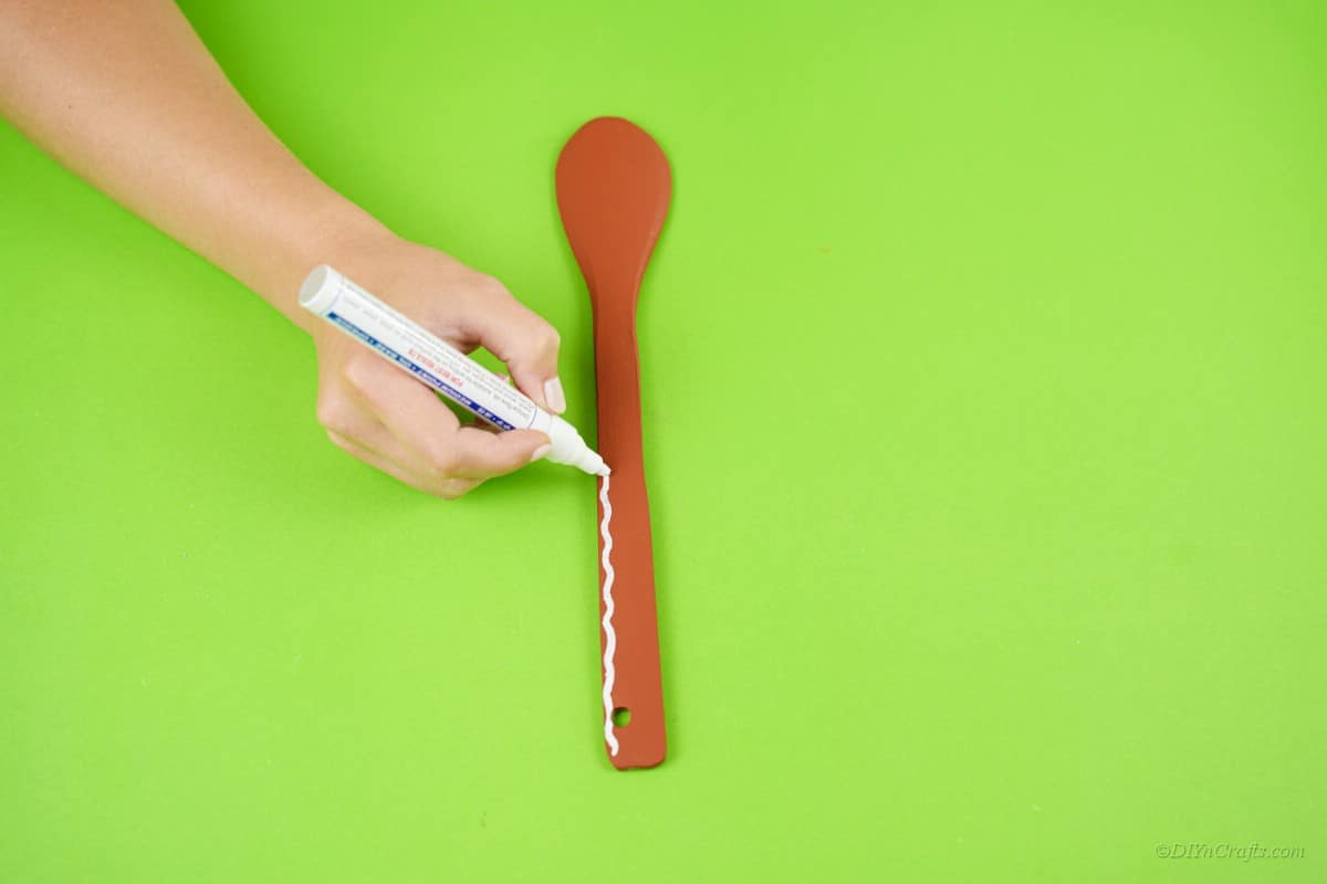 White paint marker painted wooden spoon craft