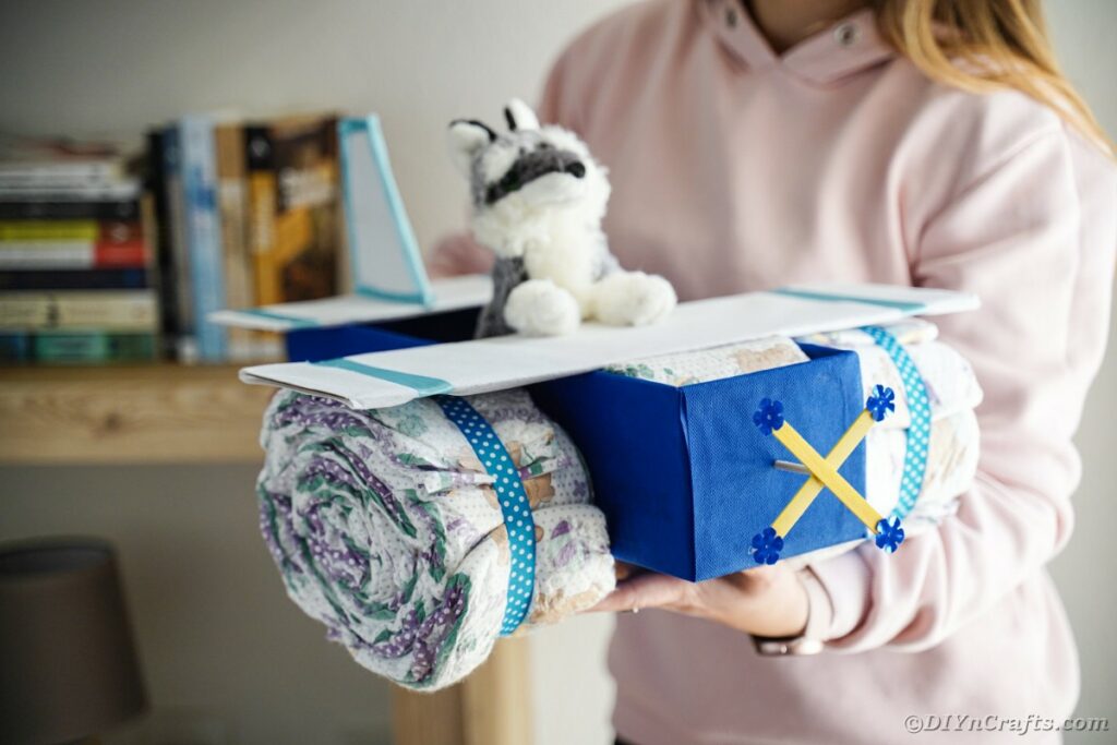 Woman holding diaper cake airplane