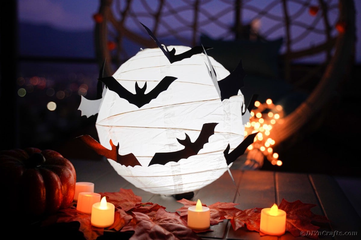 Halloween lantern on table with candles