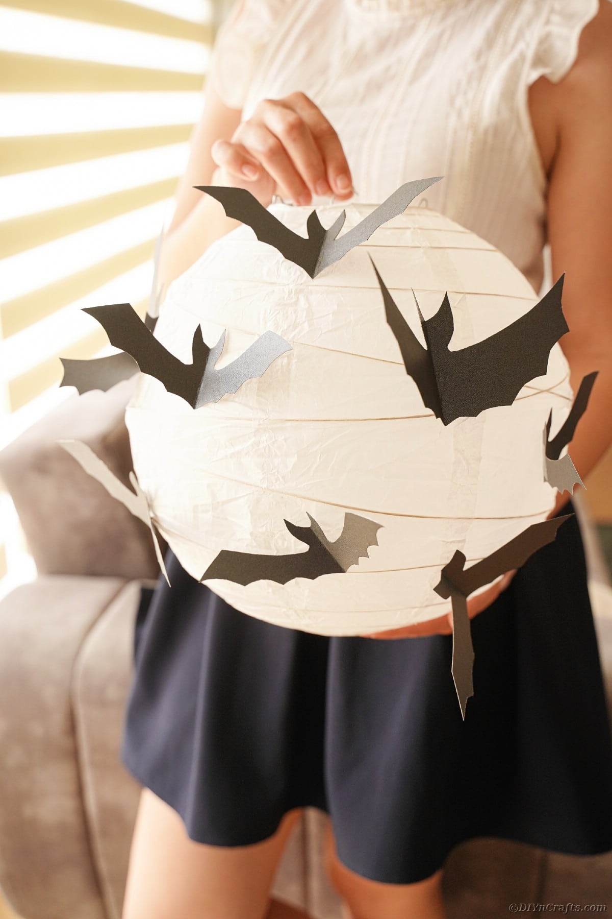 an holding paper bat lantern