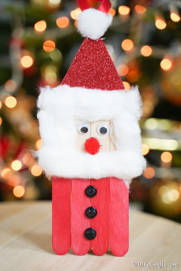 craft stick santa in front of tree