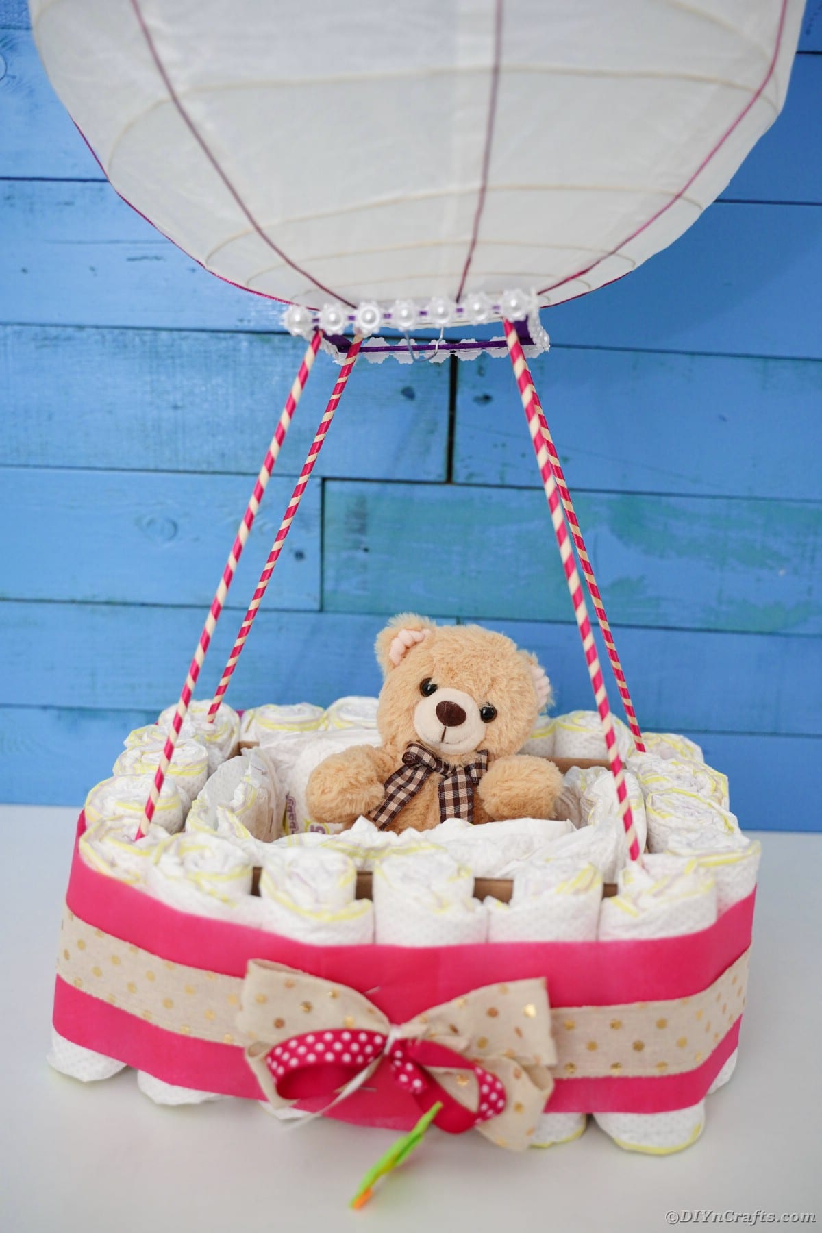 Hot air balloon diaper cake in front of blue wall