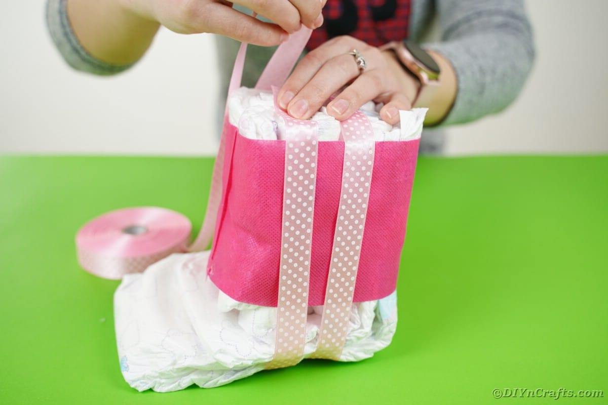 Adding ribbon to diaper roll