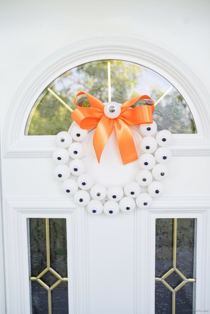 Eyeball wreath hanging on white door