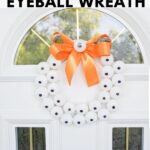 Eyeball wreath hanging on white door