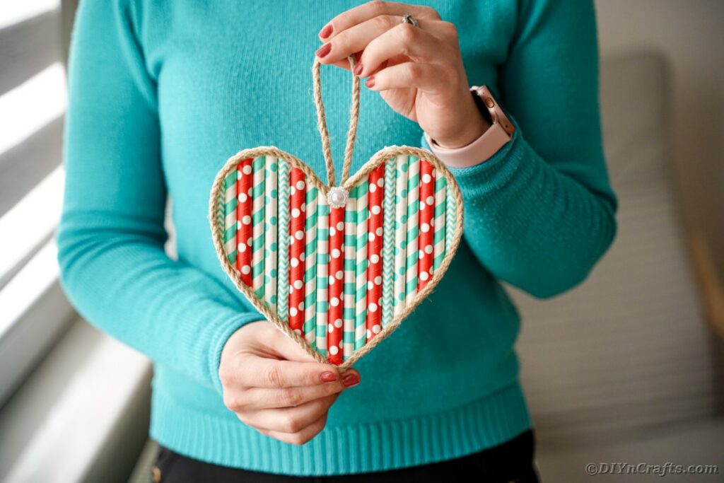 Woman holding paper straw heart